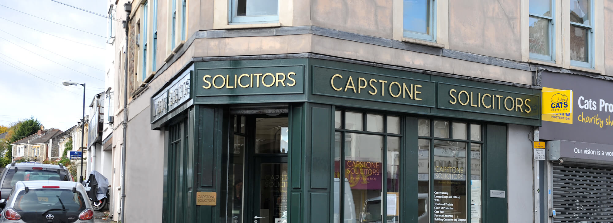 Capstone Solicitors, 62 Gloucester Road, Bishopston, Bristol. The green-painted corner shopfront with gold serif signage above the door.